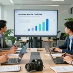 Team collaborating on business mobile deals UK in a modern office with laptops and presentation screens.